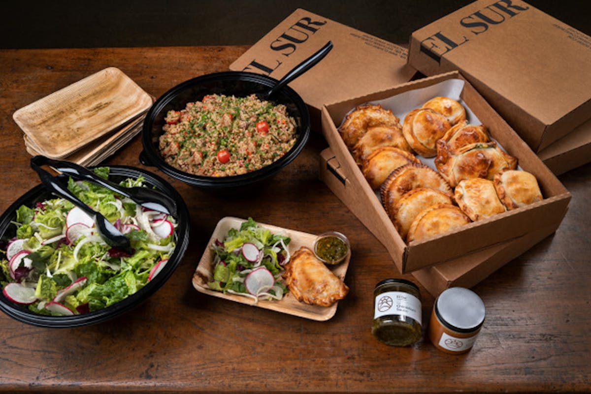 a bunch of food sitting on top of a wooden table