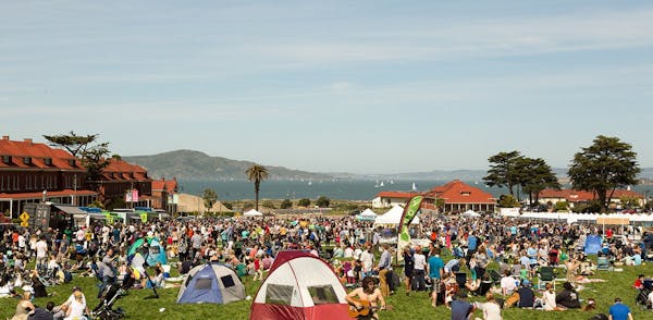 a group of people sitting at a crowded beach