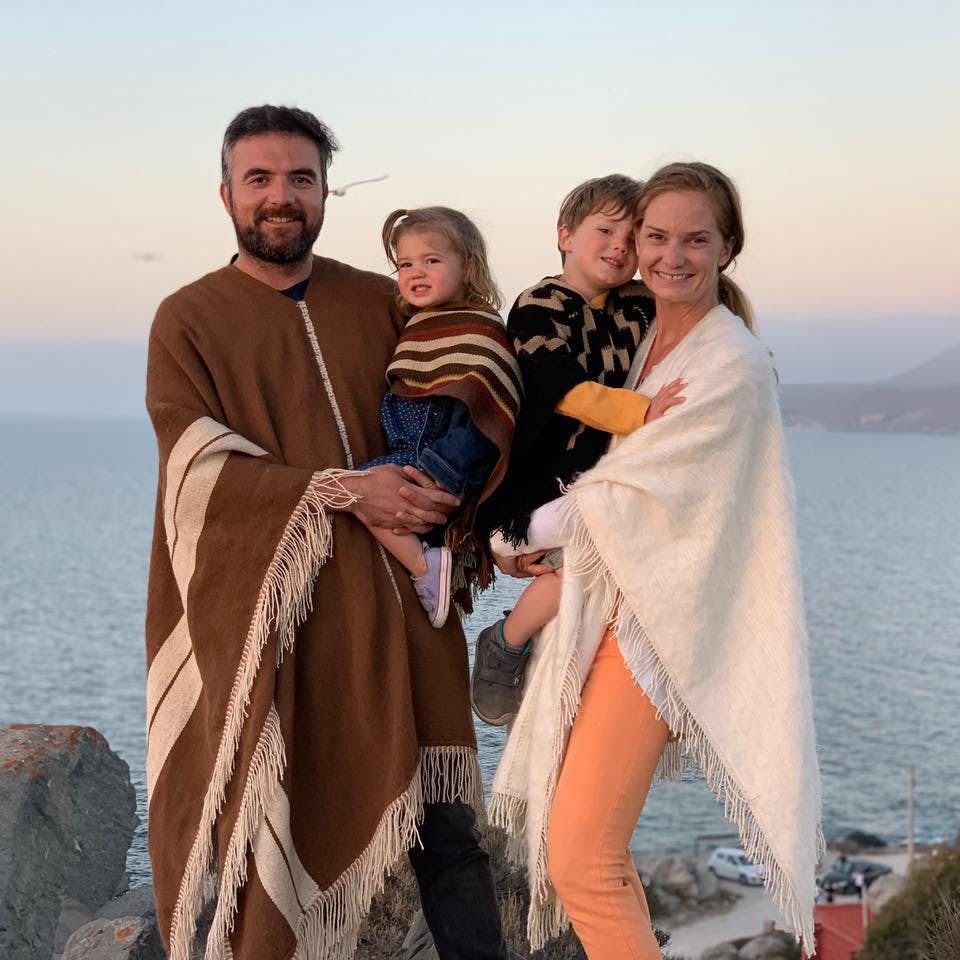 a man and a woman standing next to a body of water