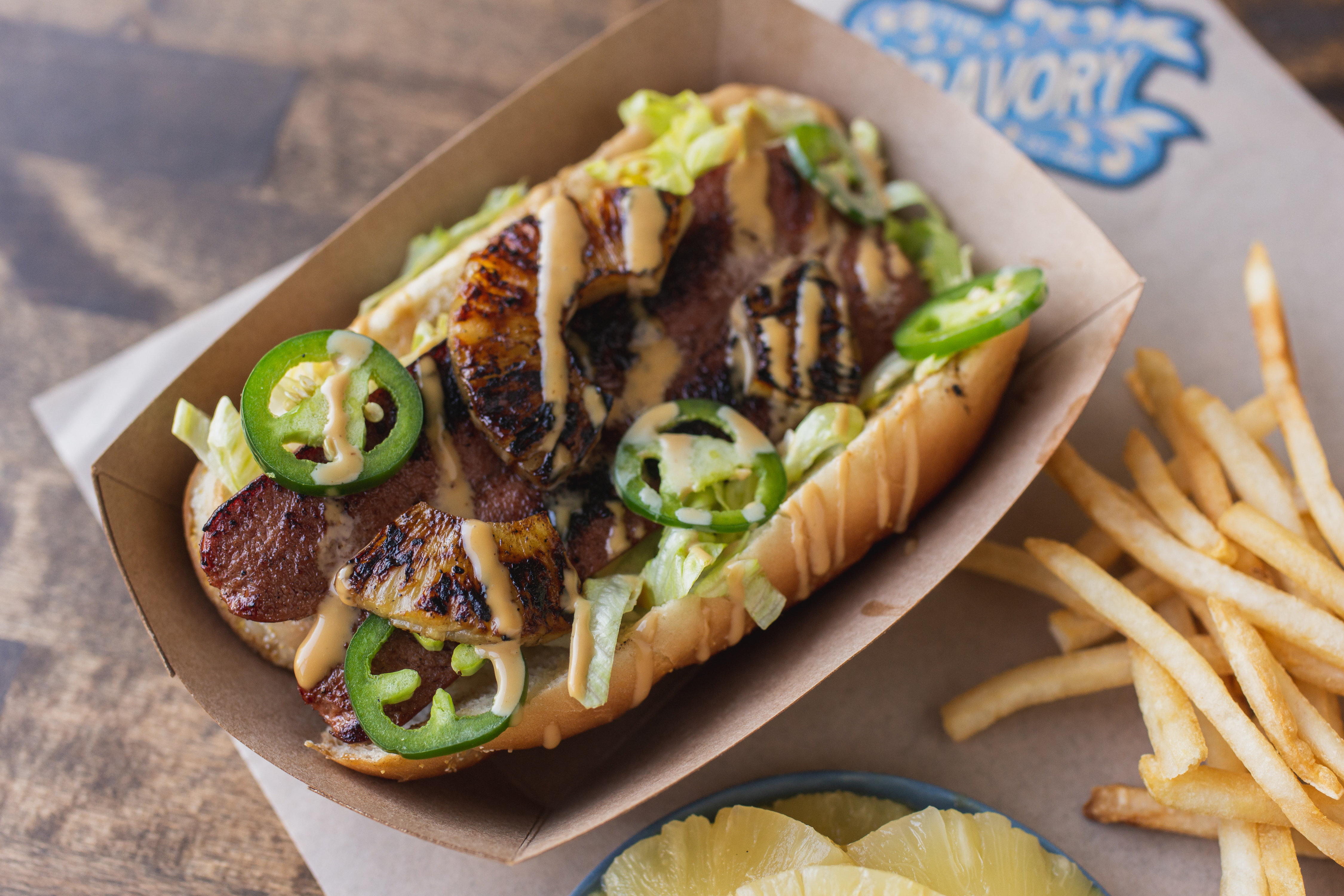 a hot dog sitting on the side of fries