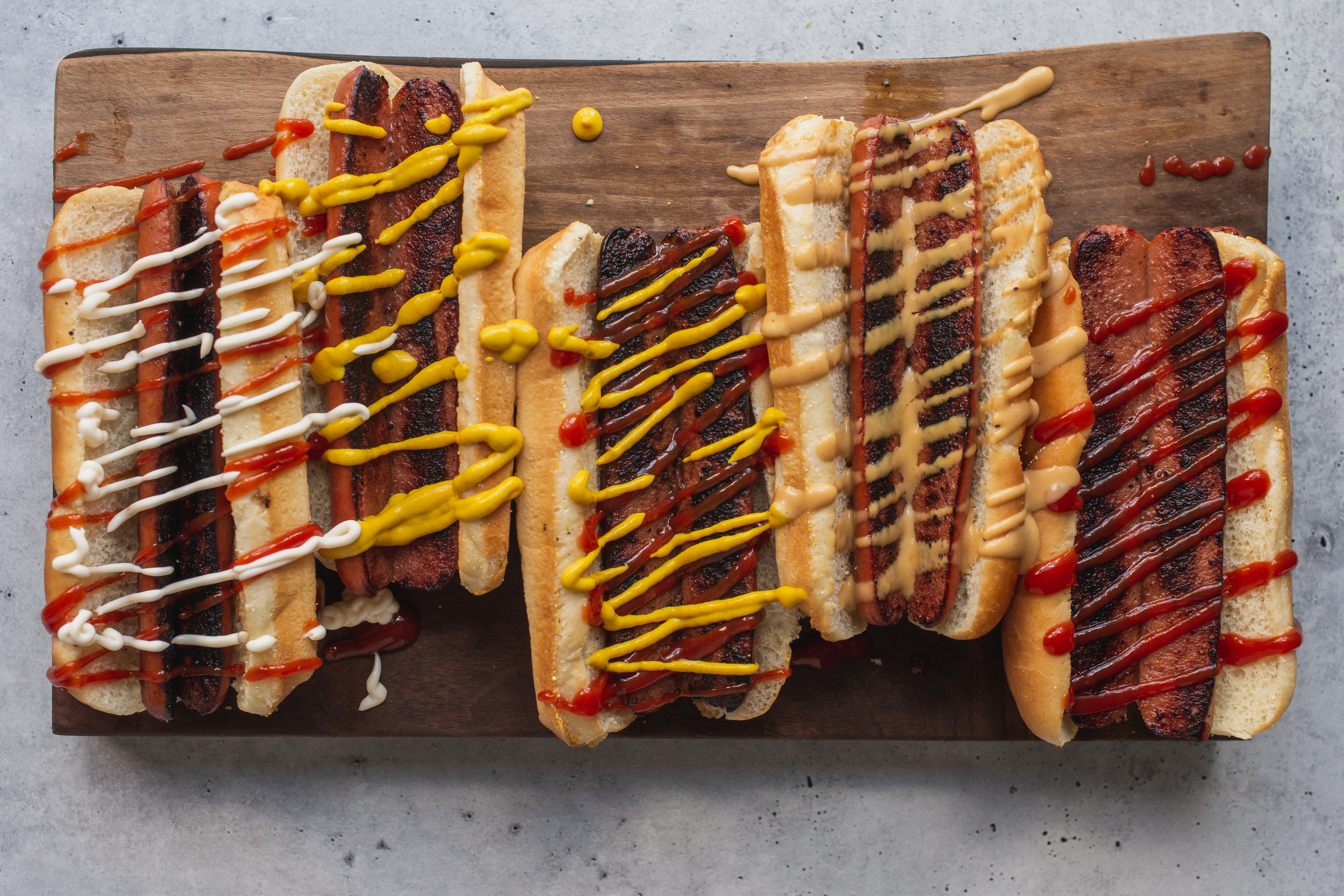 a tray of hot dogs on a grill