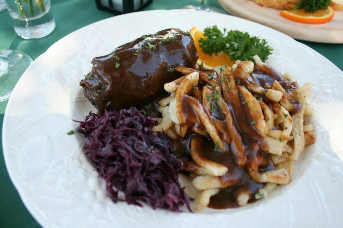 a white plate topped with meat and vegetables