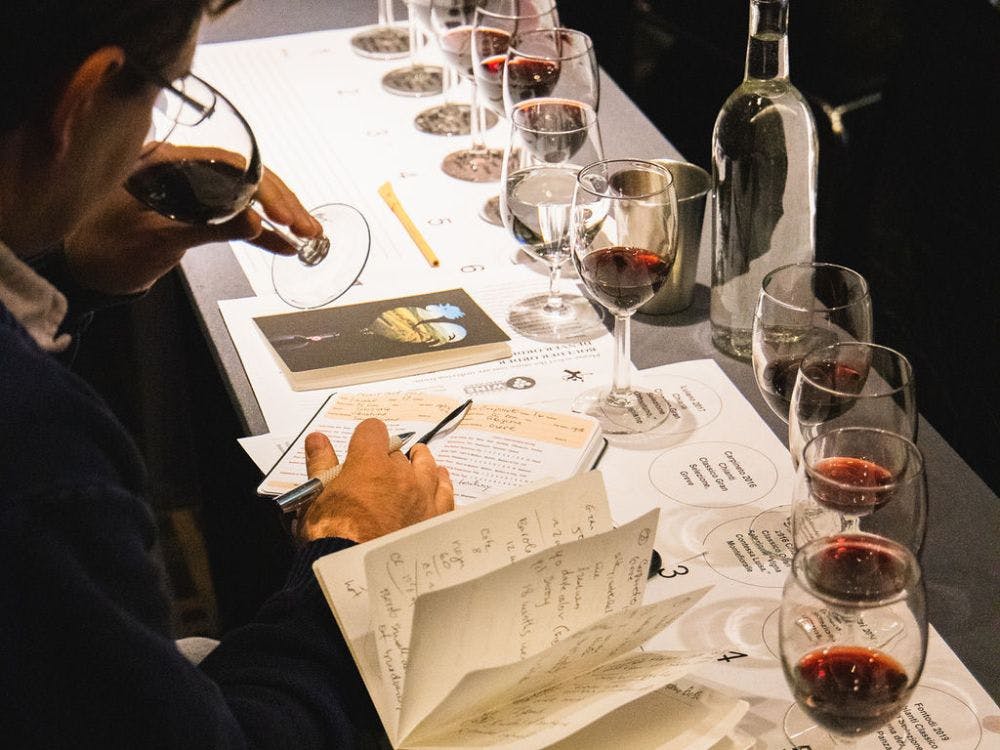 a man writing down on a notebook