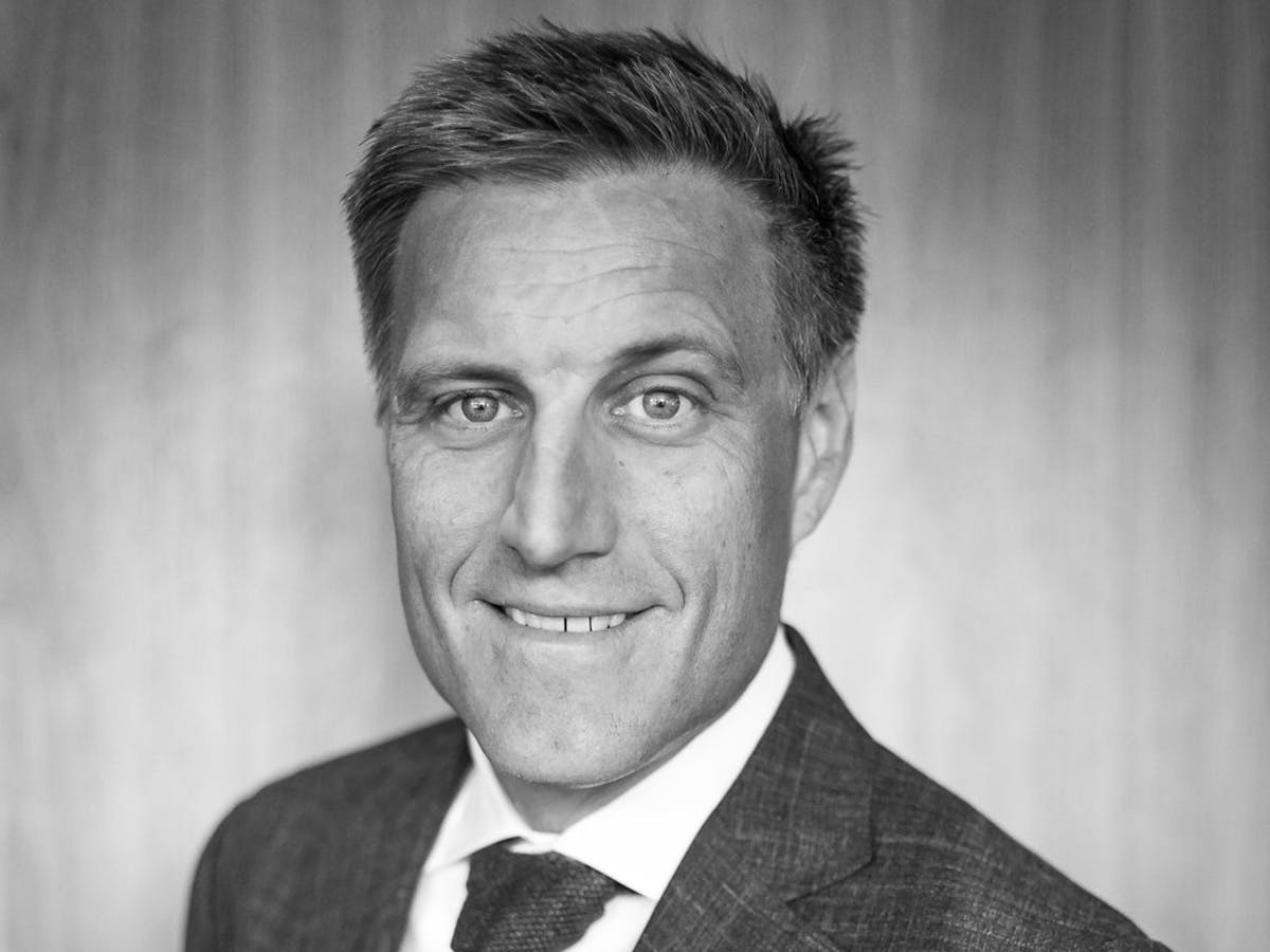 a man wearing a suit and tie looking at the camera