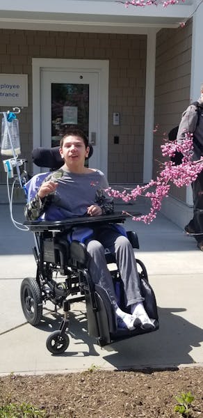 a person sitting on a motorcycle in front of a building