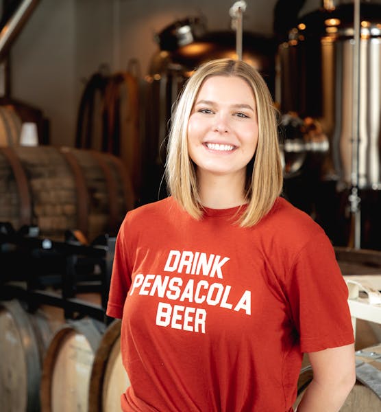 a person standing in front of a barrel