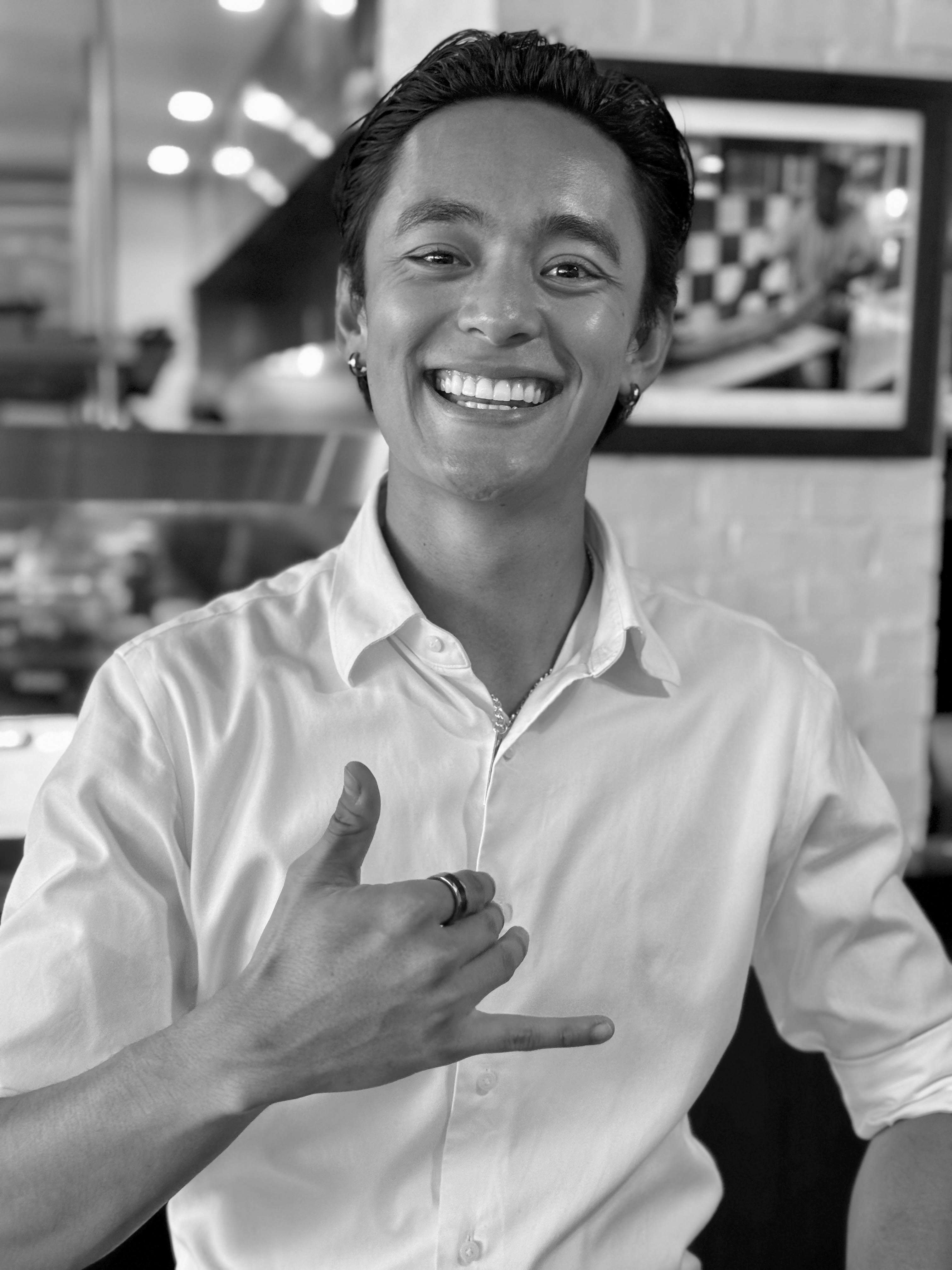 a man smiling and pointing at something