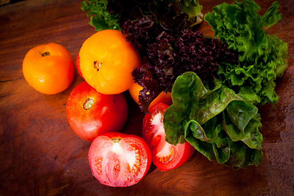 two oranges sitting on top of a wooden table