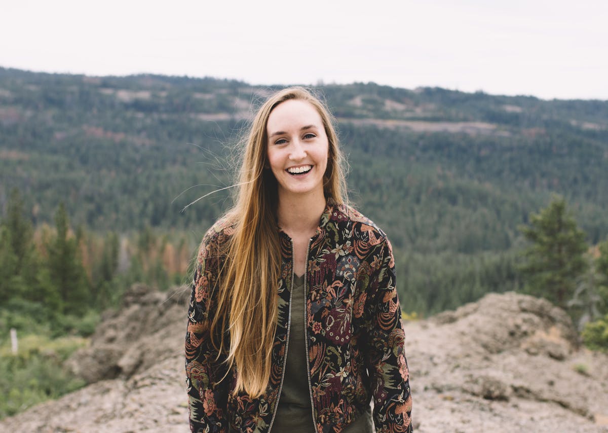 a person standing in front of a mountain