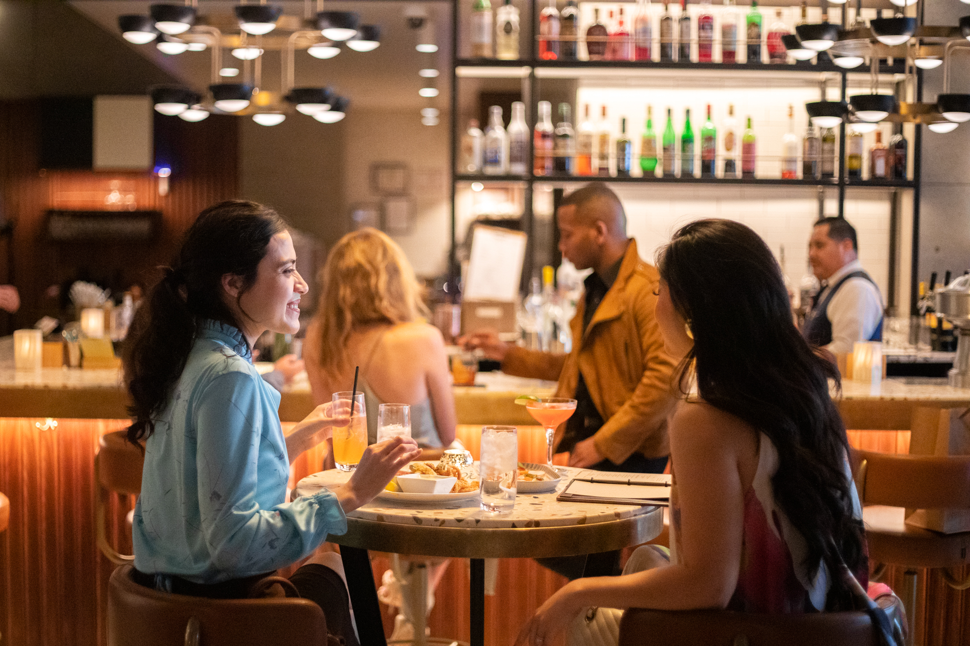 a group of people sitting at a table in a restaurant