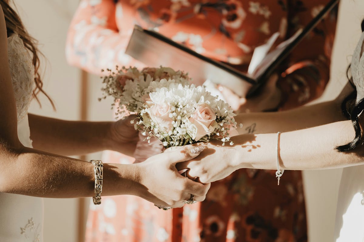 a hand holding a piece of cake