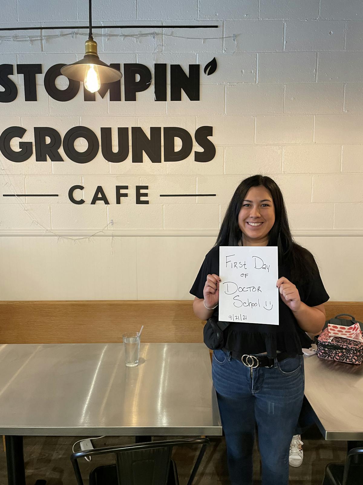 a person holding a sign posing for the camera