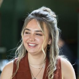 a woman standing in front of a camara