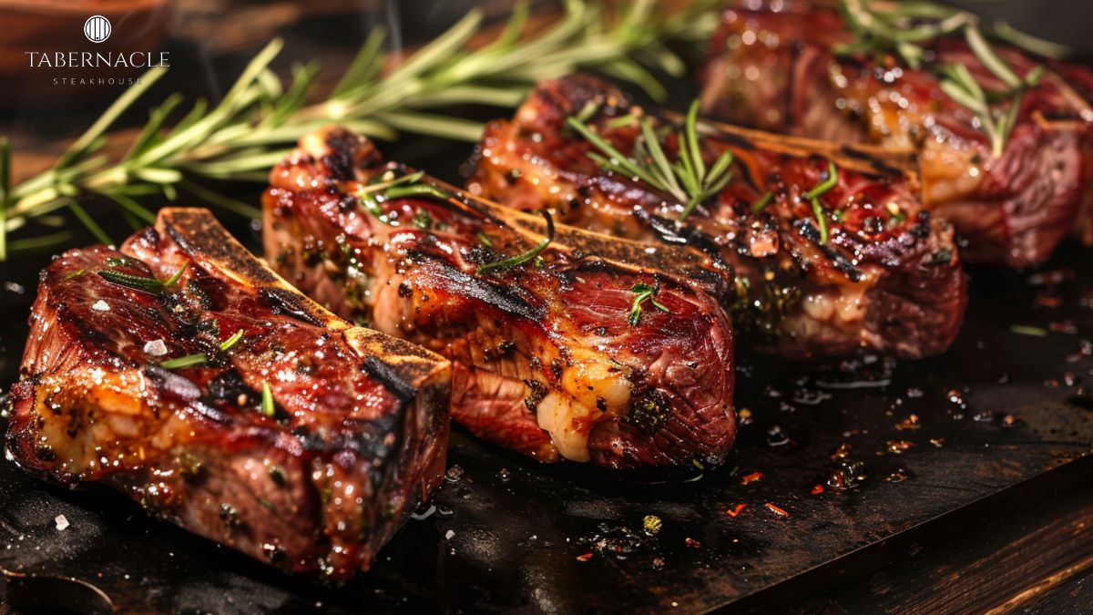 Herb-crusted kosher steaks on a wooden board at Tabernacle Steakhouse, glatt kosher NYC explained through premium cuts and preparation