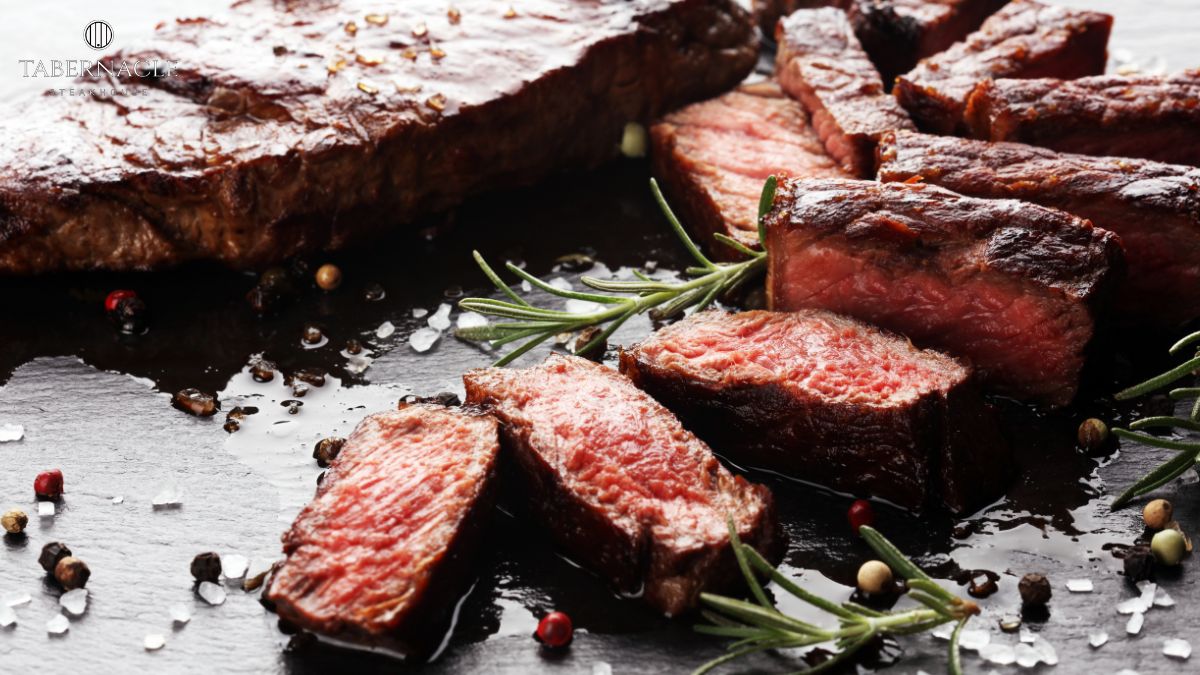 Wagyu vs Prime kosher steak sliced and served with rosemary and peppercorns at Tabernacle Steakhouse