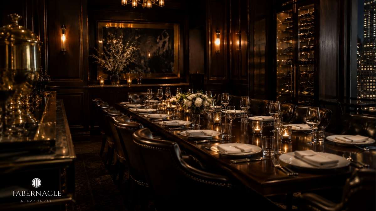 Candlelit private dining room with long table set for a formal group dinner