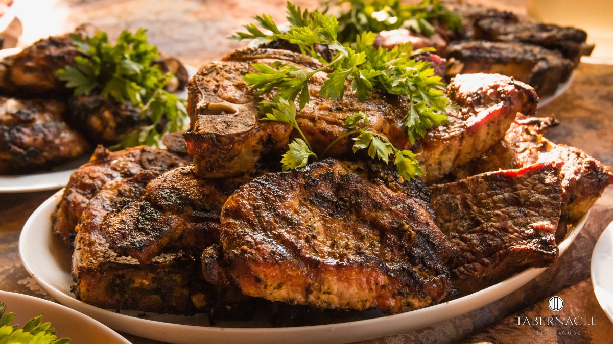 Herb-grilled kosher steaks plated and garnished with fresh parsley at Tabernacle Steakhouse, Midtown Manhattan