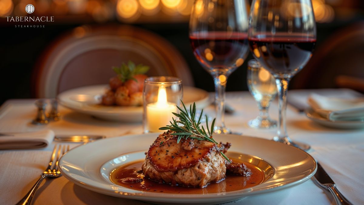 Plated kosher dinner course with red wine at a candlelit table during a Manhattan rehearsal dinner at Tabernacle Steakhouse