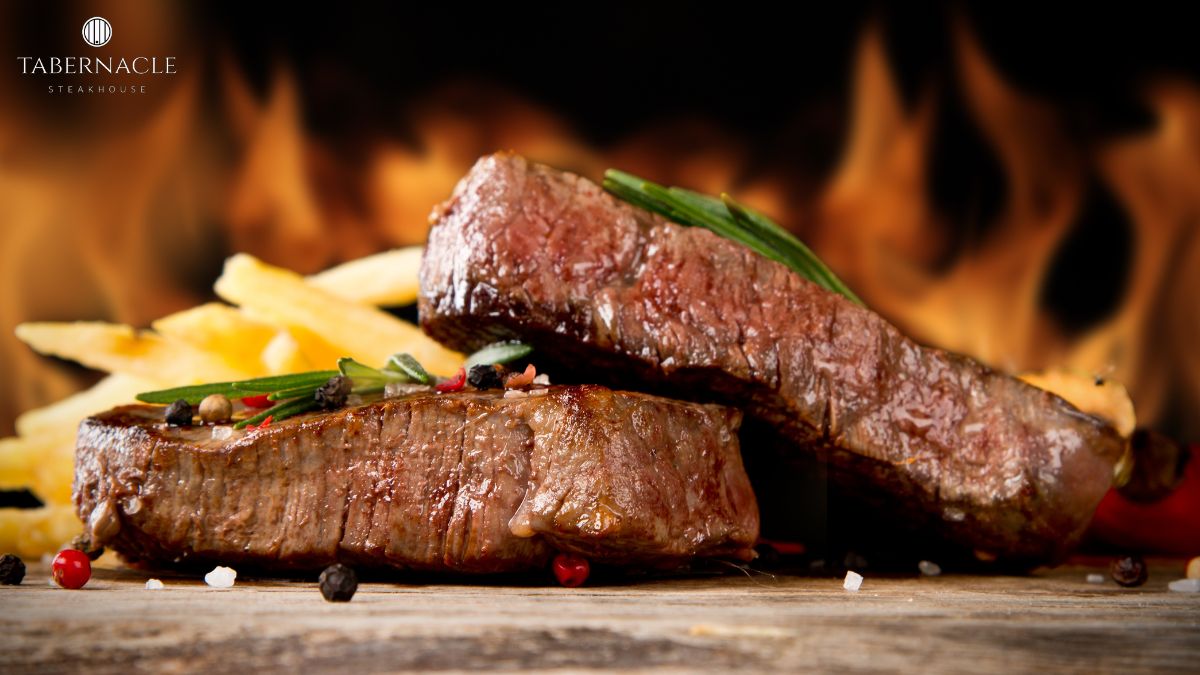 Sliced kosher steak with rosemary, peppercorns, and fries at Tabernacle Steakhouse NYC, perfect for a romantic anniversary dinner