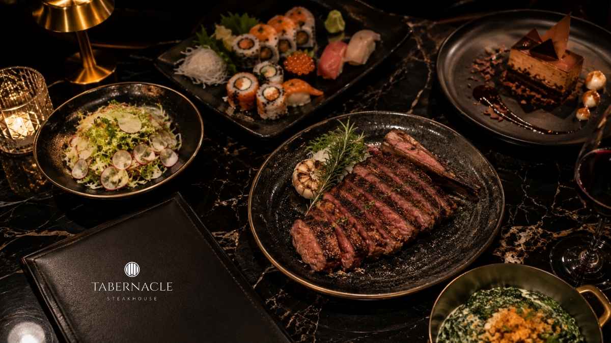 Sliced steak, sushi platter, salad, dessert, and sides on a dinner table