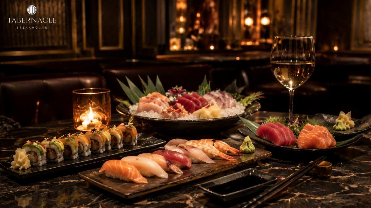 Sushi rolls, nigiri, and sashimi platters with white wine in a candlelit dining room