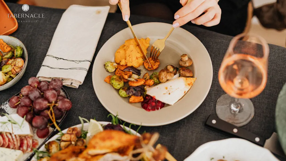 Guest enjoying roasted vegetables and seasonal sides at a kosher dinner in Manhattan at Tabernacle Steakhouse