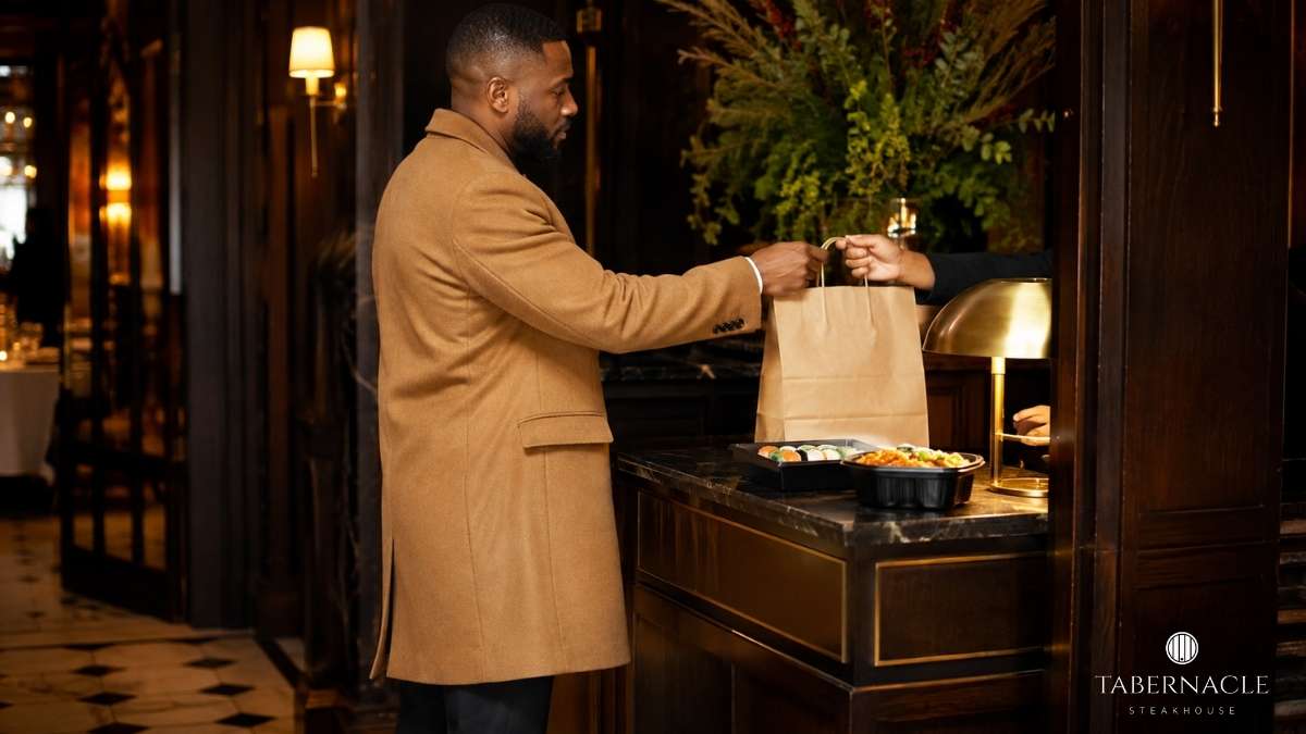 man-picking-up-takeout-bag-at-upscale-restaurant-counter