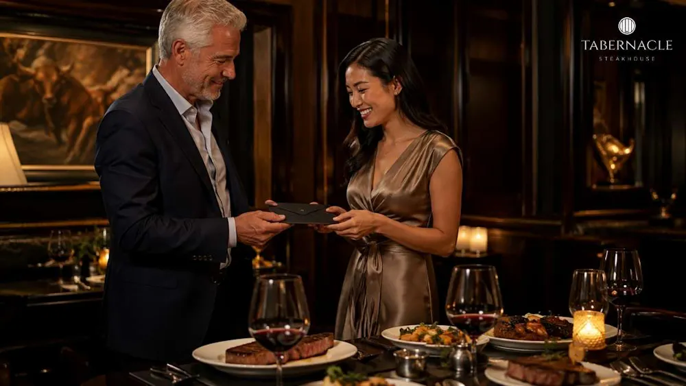 man-presenting-gift-card-to-woman-at-upscale-steakhouse-dinner