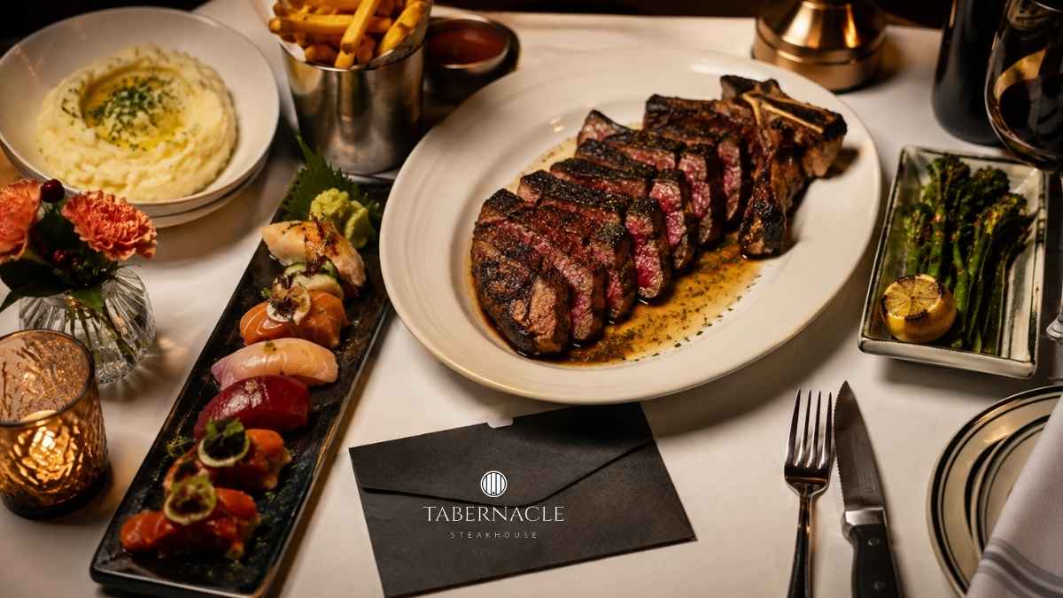 sliced-tomahawk-steak-sushi-sides-and-gift-card-on-table