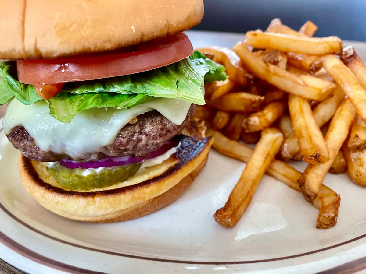 a sandwich with lettuce and fries on a plate
