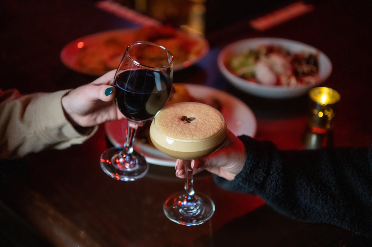 a hand holding a glass of wine