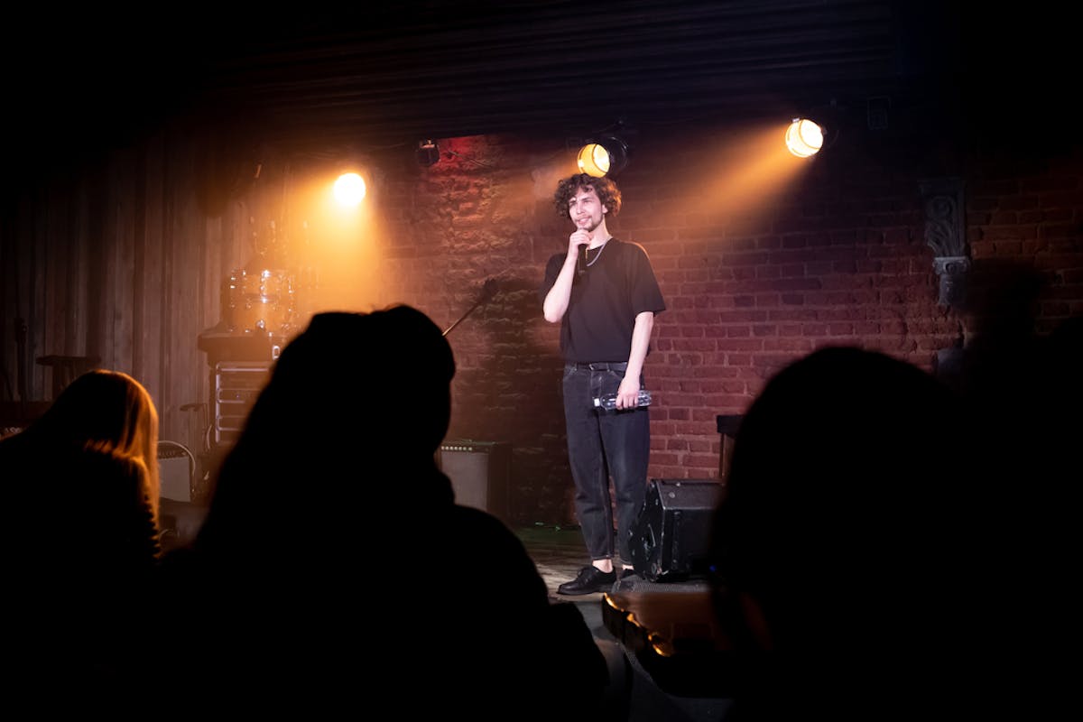 a man and a woman standing in a dark room