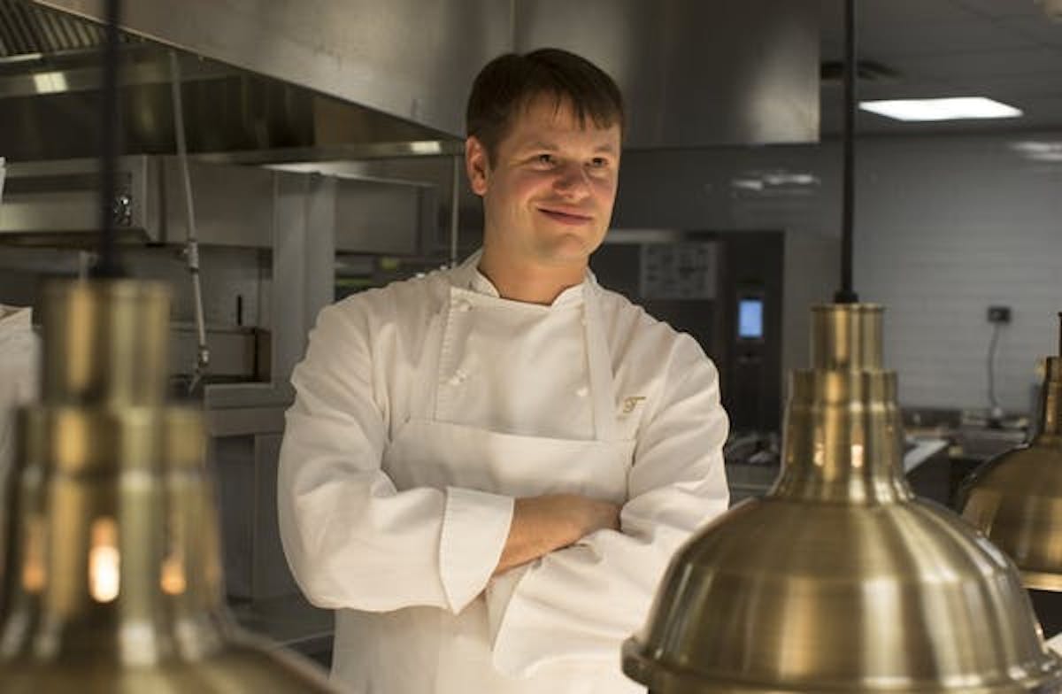a person standing in a kitchen preparing food