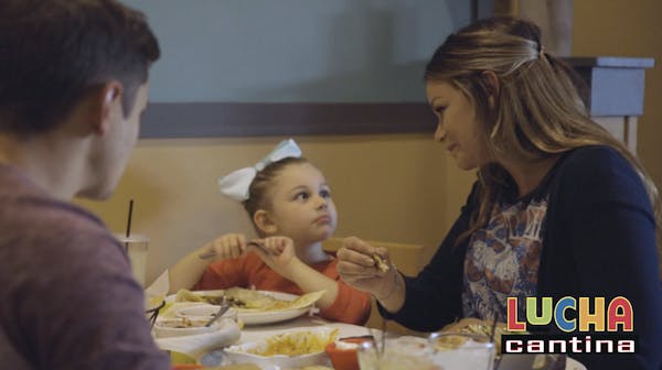 a woman sitting at a table eating food