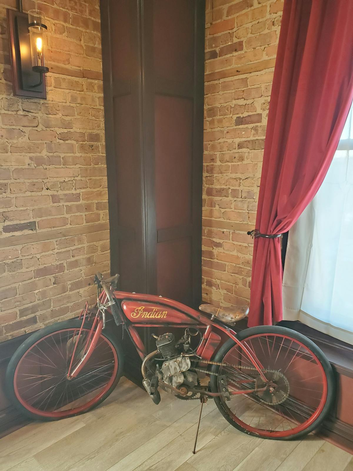 a bicycle parked in front of a brick building