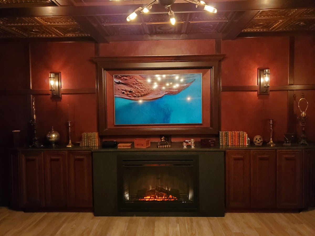 a flat screen tv sitting on top of a stove