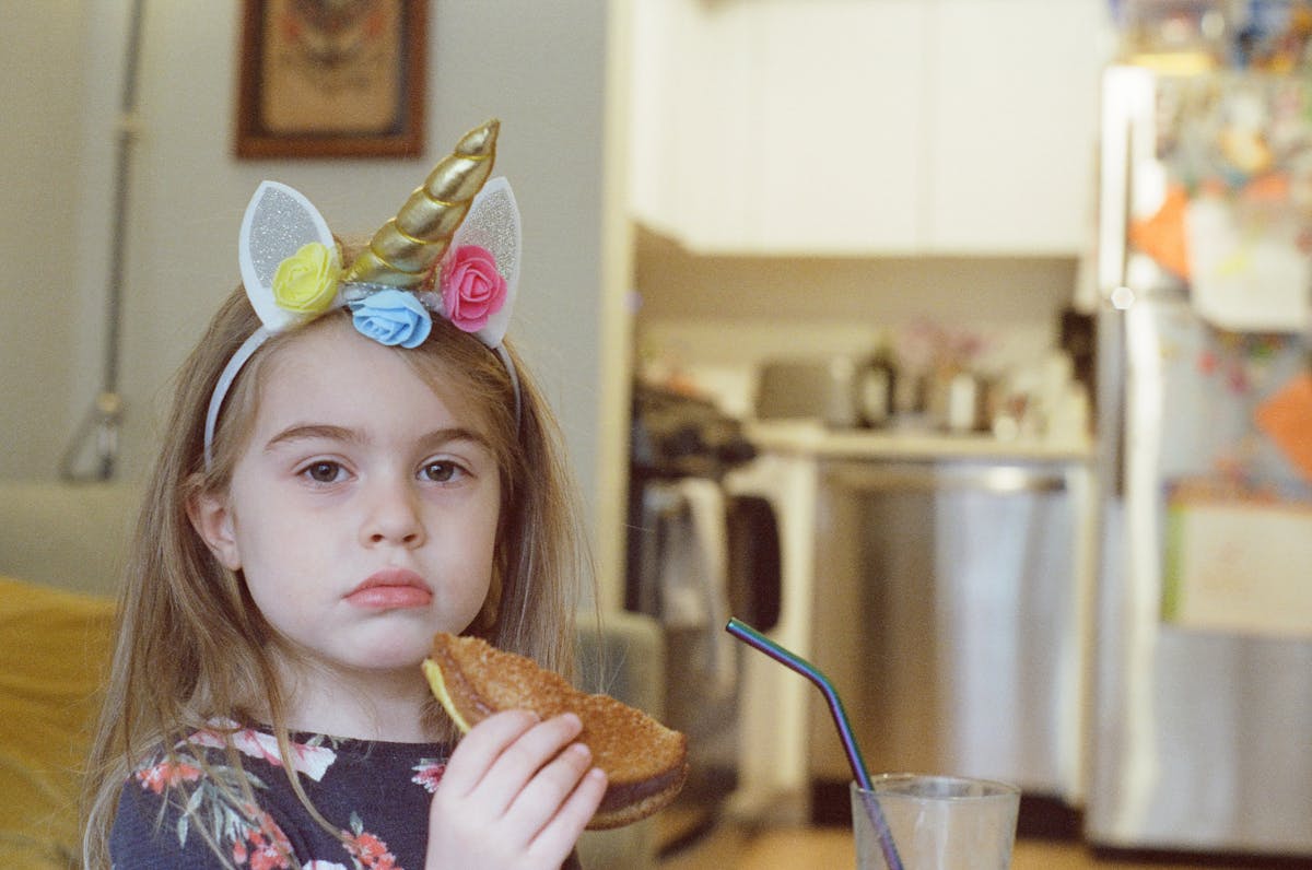a little girl that is eating some food