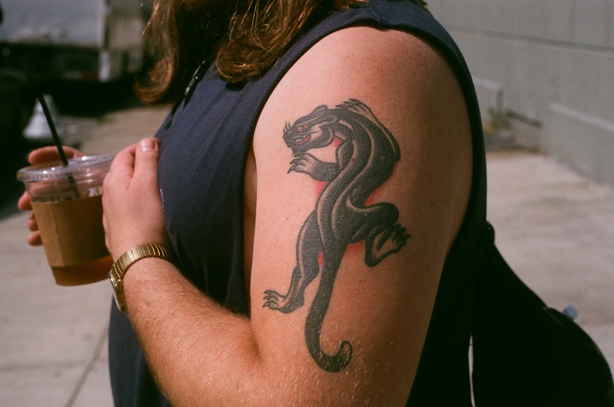 a person holding a tattoo of a woman