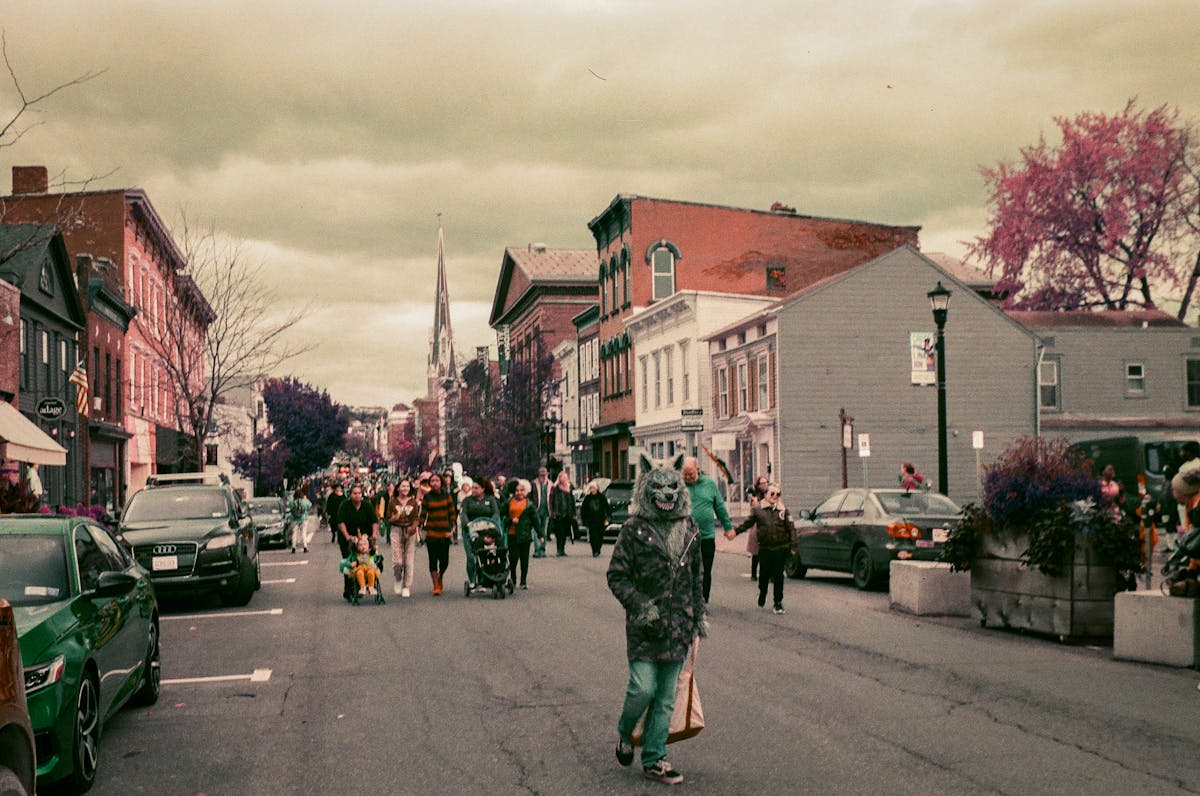a group of people walking on a city street