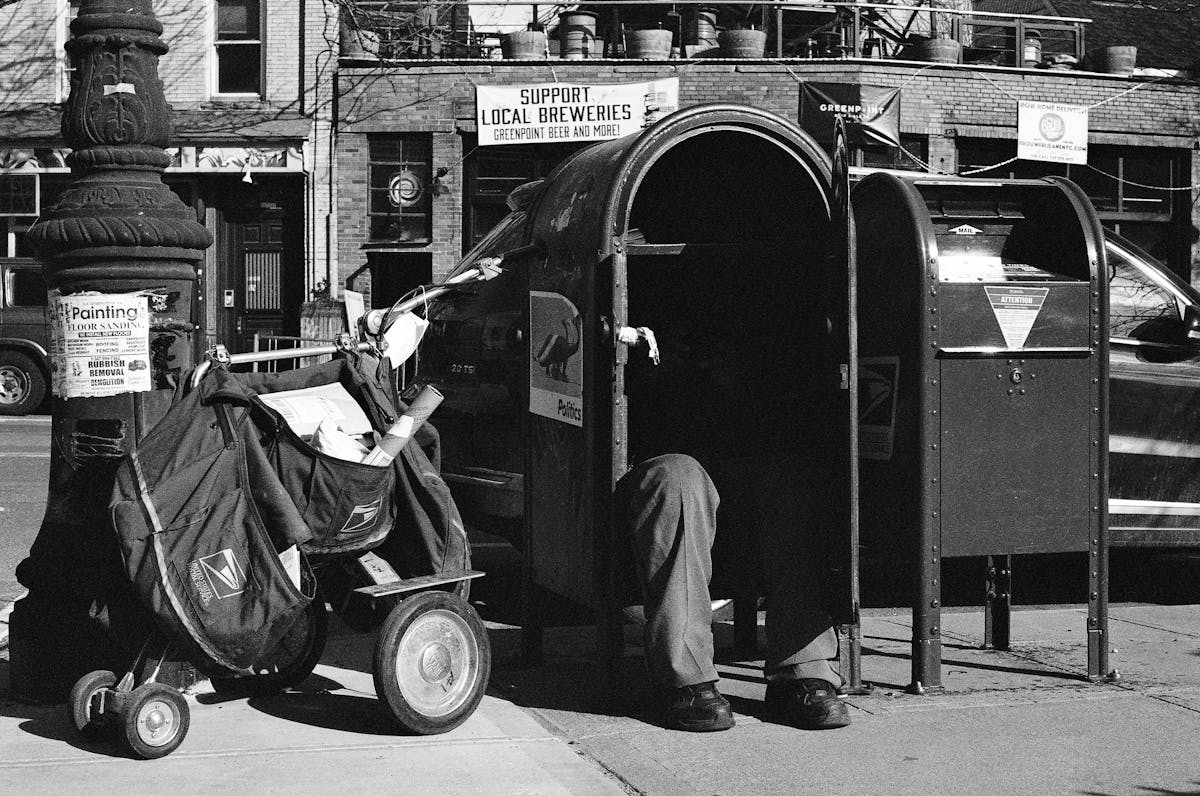 a man sitting on a motorcycle in front of a building