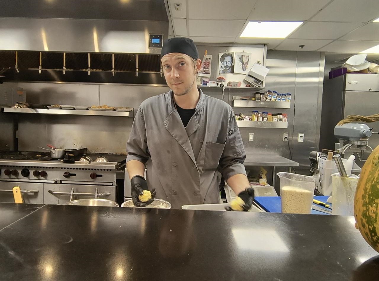 a man standing in a kitchen preparing food