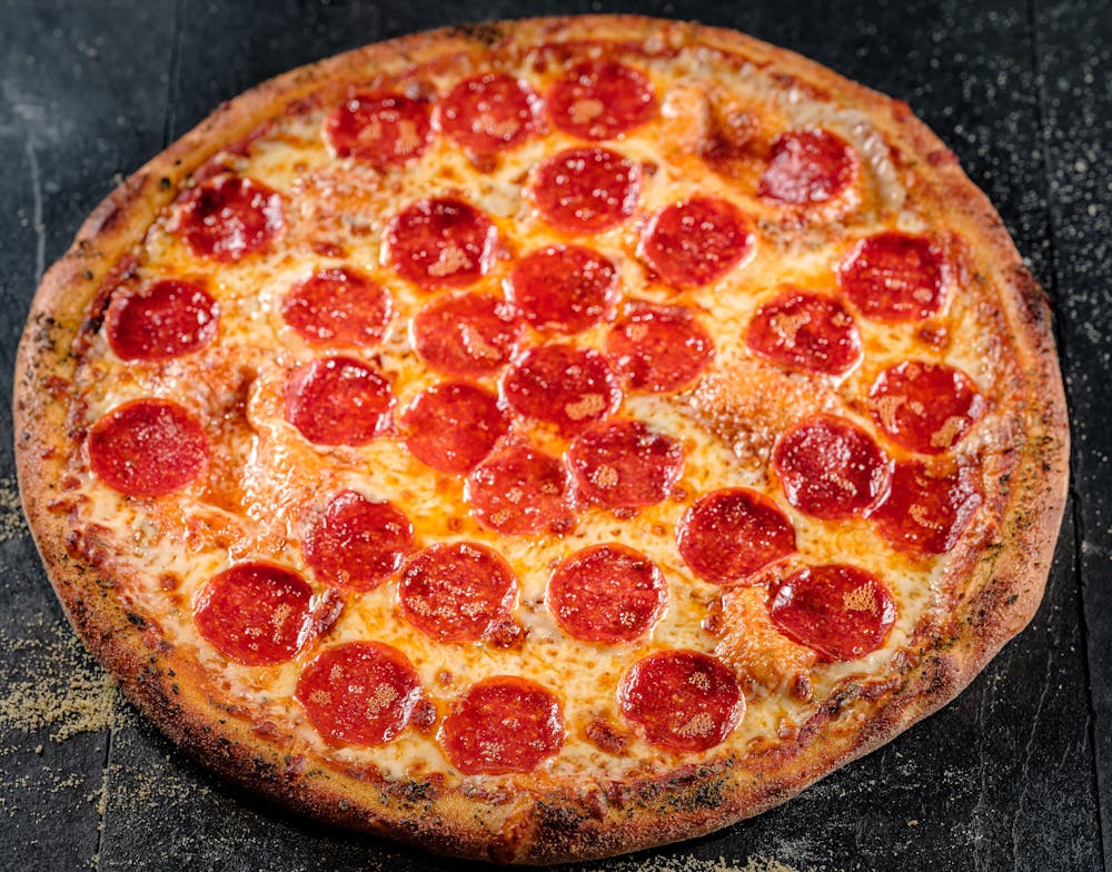 a large pepperoni pizza on a pan
