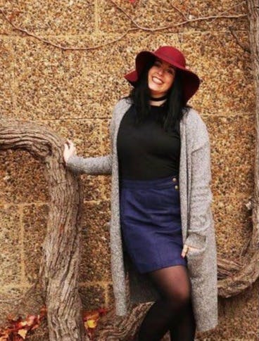 a person standing in front of a brick wall