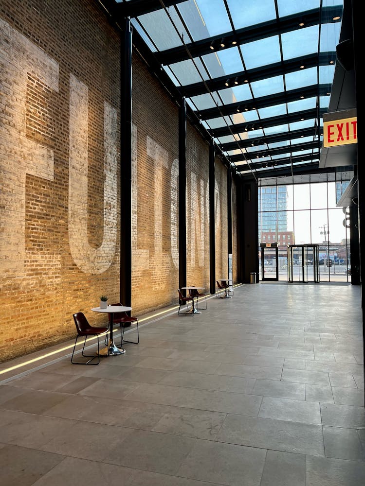 a bench in front of a brick building