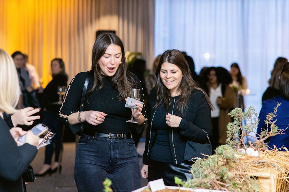 a group of people standing in front of a curtain