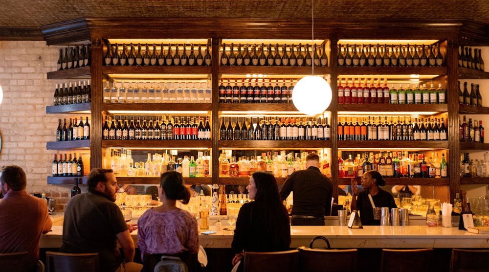 a group of people sitting at a table in front of a store