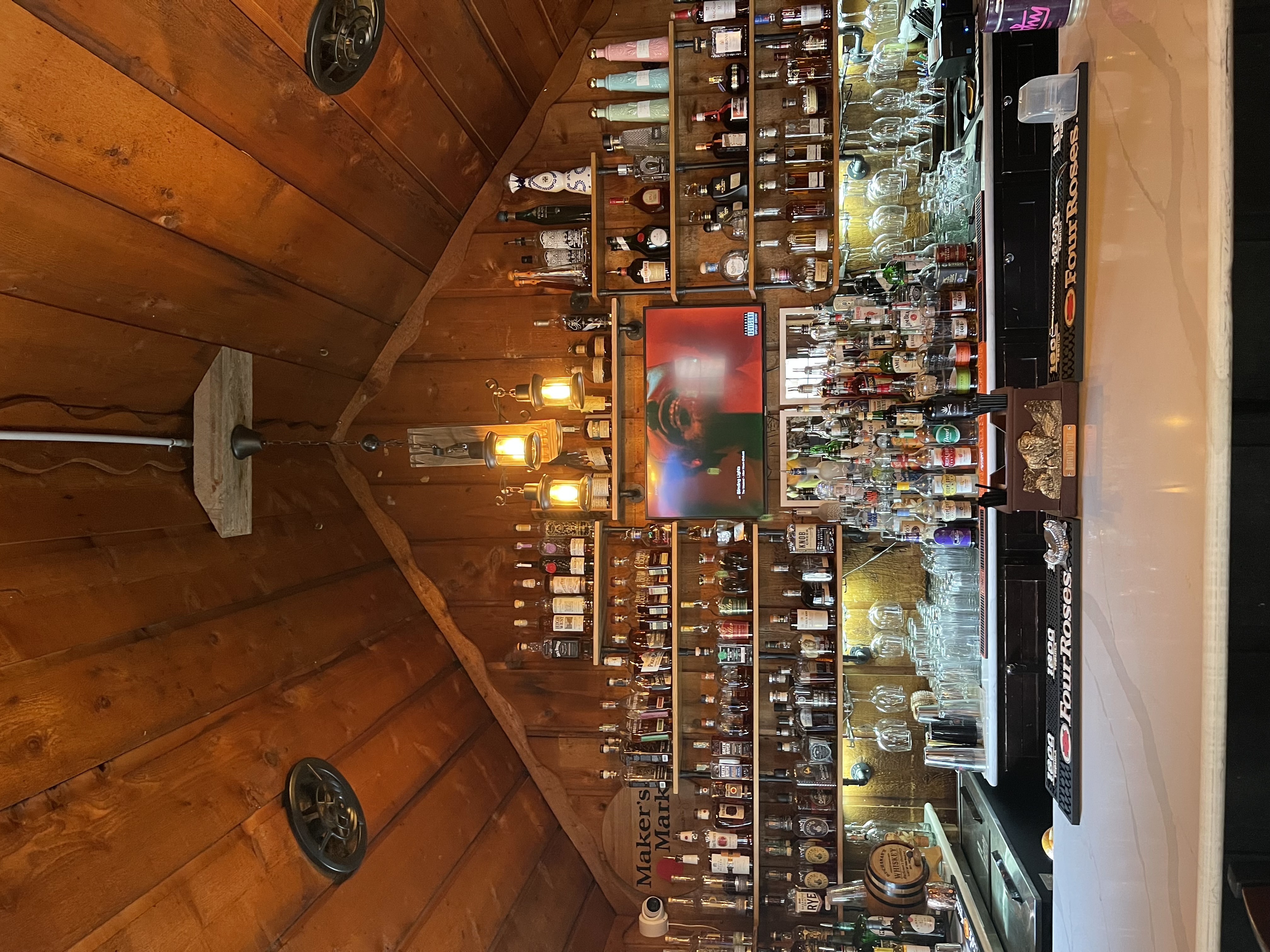 a bar with many bottles and glasses