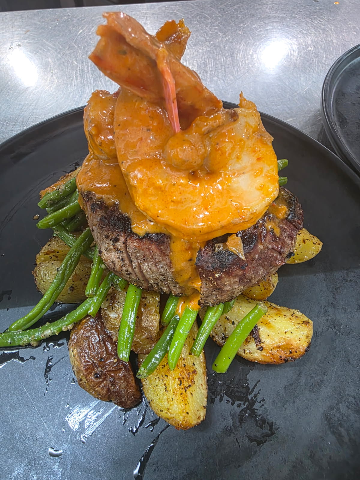 a plate of food with shrimp and potatoes