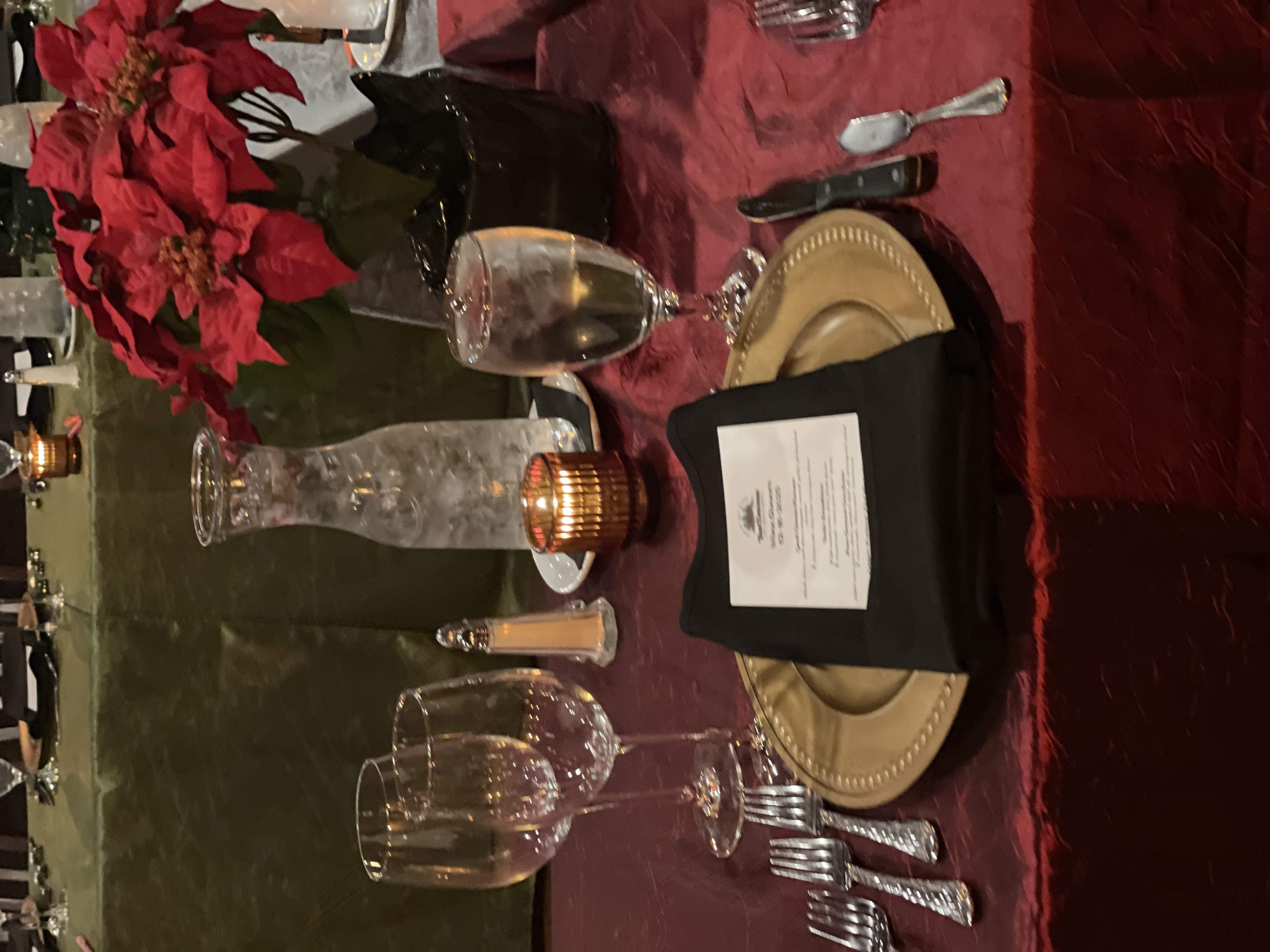 a table with a plate and glasses and a candle