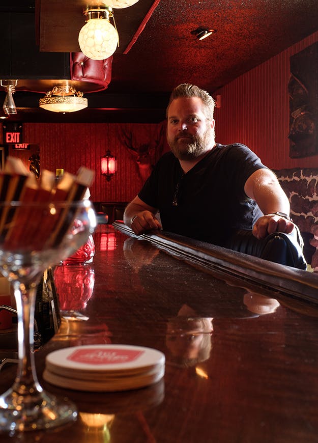 Stephen Lukach sitting at a table with wine glasses